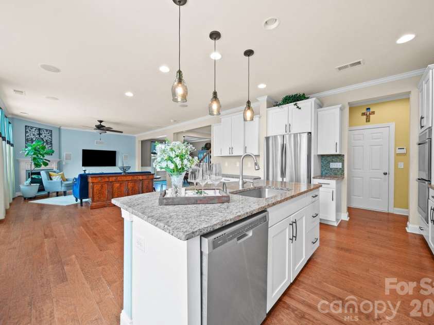 148 Byers Commons Drive, Mooresville, NC 28117.  MLS# CAR4368080, YatesRealty ID 27301. Another view of the kitchen, seamlessly connecting to the expansive great room and offering excellent space for entertaining.
