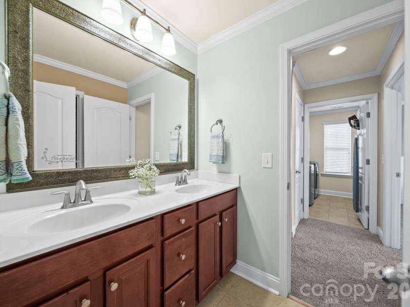 148 Byers Commons Drive, Mooresville, NC 28117.  MLS# CAR4368080, YatesRealty ID 27301. Full guest bathroom with dual vanity and separate water closet and shower.