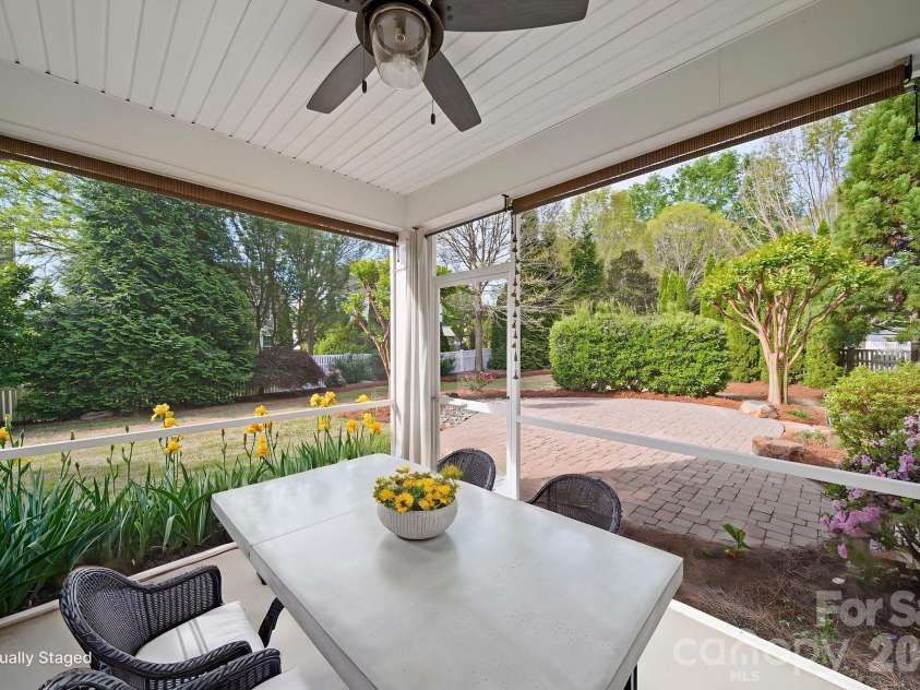 148 Byers Commons Drive, Mooresville, NC 28117.  MLS# CAR4368080, YatesRealty ID 27301. Screened in back porch, virtually staged to capture the calm backyard setting, ideal for both entertaining and quiet moments of relaxation.