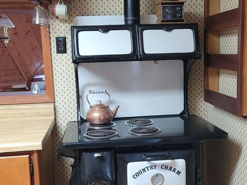 60 Persimmons Lane, Burnsville, NC 28714.  MLS# CAR4287667, YatesRealty ID 2731. Old Woodstove that has been electrified