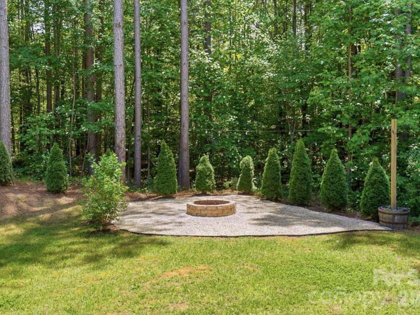 145 Crooked Branch Way, Troutman, NC 28166.  MLS# CAR4385546, YatesRealty ID 27315. Backyard fire pit
