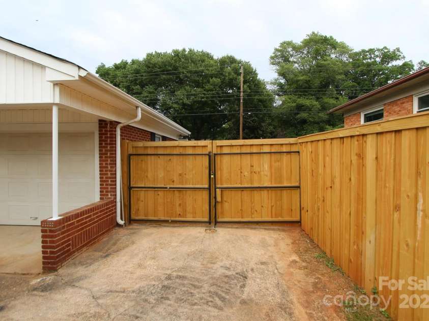 1421 Thompson Avenue, Charlotte, NC 28216.  MLS# CAR4259124, YatesRealty ID 27317. 12' wide gate to access back yard