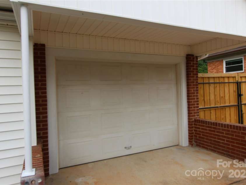 1421 Thompson Avenue, Charlotte, NC 28216.  MLS# CAR4259124, YatesRealty ID 27317. 13'x20' attached rear entrance garage
