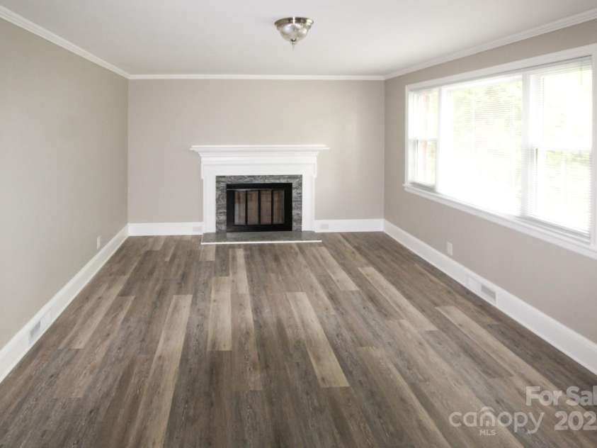 1421 Thompson Avenue, Charlotte, NC 28216.  MLS# CAR4259124, YatesRealty ID 27317. Large living room with fireplace