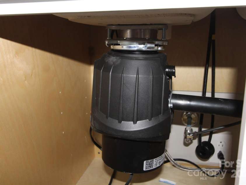 1421 Thompson Avenue, Charlotte, NC 28216.  MLS# CAR4259124, YatesRealty ID 27317. New garbage disposal with counter top push button switch