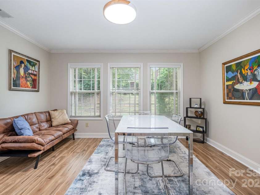 168 Columns Circle, Shelby, NC 28150.  MLS# CAR4282317, YatesRealty ID 27323. Spacious sunroom overlooks the private back patio--currently used as a dining room but could be an office, den, or sunroom!