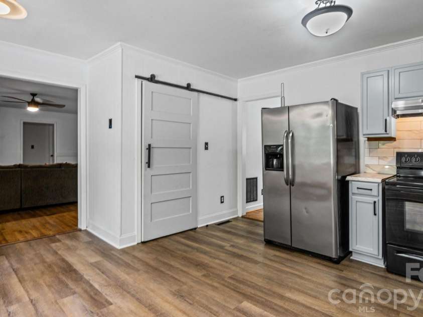 2106 Arden Drive, Monroe, NC 28112.  MLS# CAR4387611, YatesRealty ID 27335. Kitchen with sliding barn door pantry