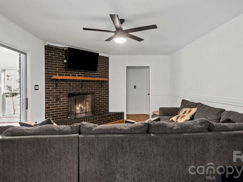 2106 Arden Drive, Monroe, NC 28112.  MLS# CAR4414733, YatesRealty ID 27335. Family room with fireplace...virtually enhanced
