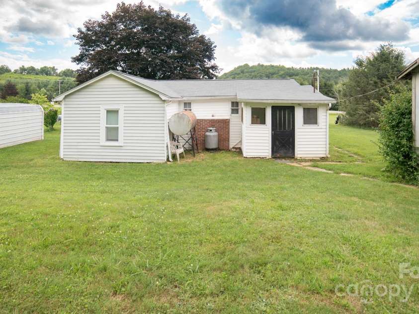 7610 Linville Falls Highway, Newland, NC 28657.  MLS# CAR4275283, YatesRealty ID 27338. Back Yard,Carport,and Outbuilding