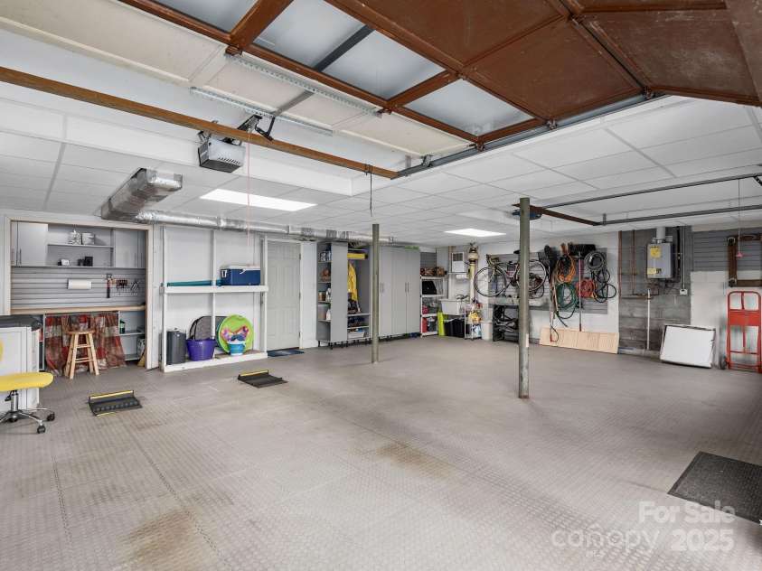 324 Woody Lane, Asheville, NC 28804.  MLS# CAR4235932, YatesRealty ID 27341. Dropped ceiling added, customized wall units, slat board, workbench and flooring laid