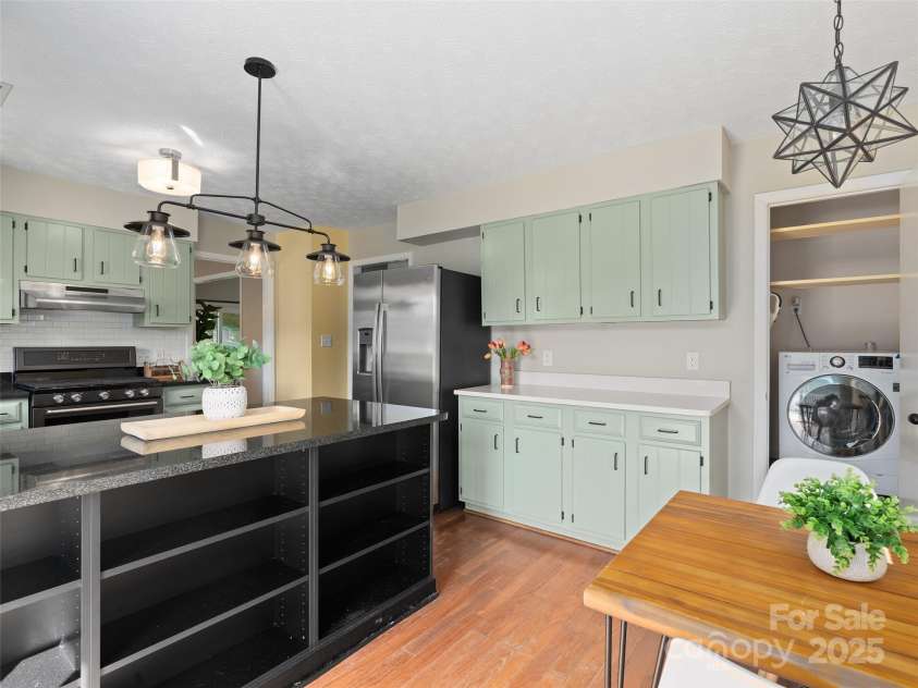 324 Woody Lane, Asheville, NC 28804.  MLS# CAR4235932, YatesRealty ID 27341. LG Invertor single unit washer and dryer in kitchen making true one leveling living