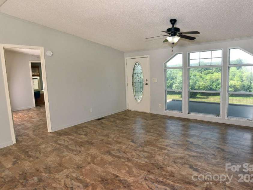 1924 Junction Road, Mocksville, NC 27028.  MLS# CAR4279453, YatesRealty ID 27346. Living Room - Entrance to Primary Bedroom