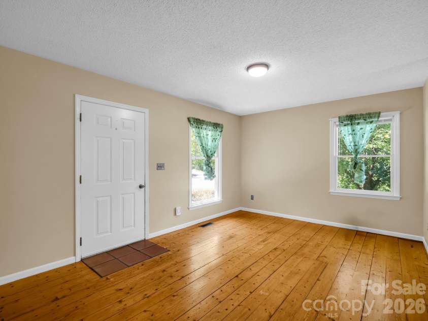 255 & 257 Crescent Street, Saluda, NC 28773.  MLS# CAR4383610, YatesRealty ID 27346. Living Room/Entry