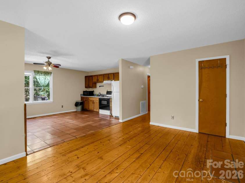 255 & 257 Crescent Street, Saluda, NC 28773.  MLS# CAR4383610, YatesRealty ID 27346. Living Room/Kitchen