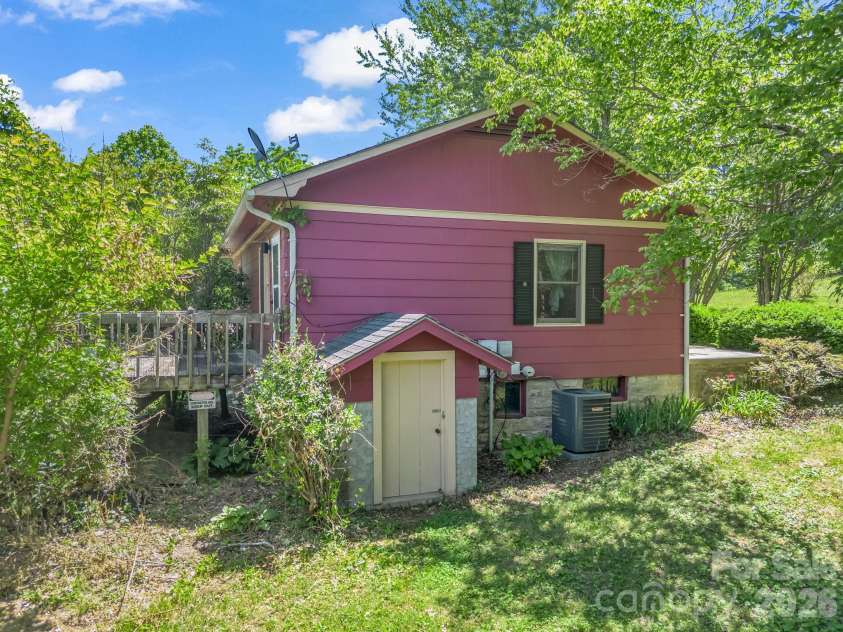 255 & 257 Crescent Street, Saluda, NC 28773.  MLS# CAR4383610, YatesRealty ID 27346. Red House (side view to basement entry)
