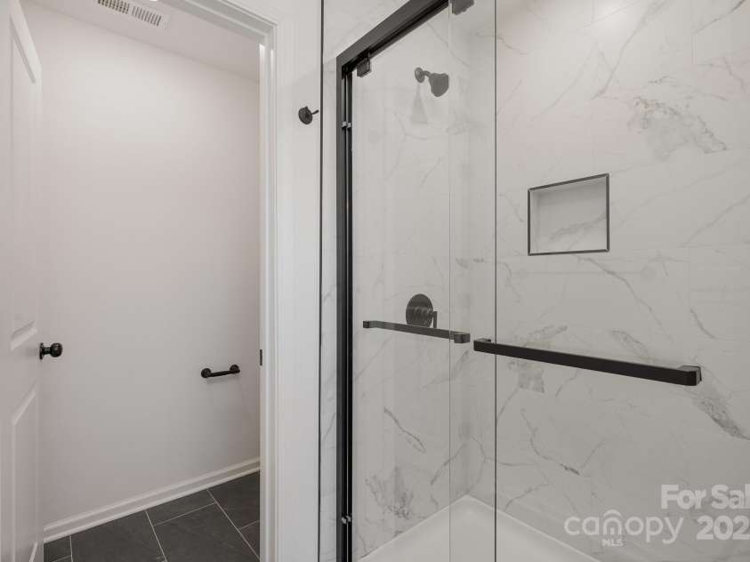 2016 Sadler Woods Lane, Charlotte, NC 28214.  MLS# CAR4220744, YatesRealty ID 2735. Framed shower. Representative Photo