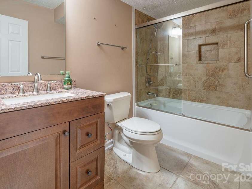 100 Thistle Knoll Court, Asheville, NC 28803.  MLS# CAR4278085, YatesRealty ID 27367. Guest bath in basement level