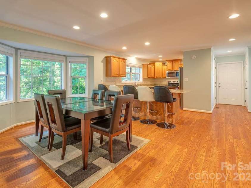 100 Thistle Knoll Court, Asheville, NC 28803.  MLS# CAR4278085, YatesRealty ID 27367. Open living area extending to a dining room.