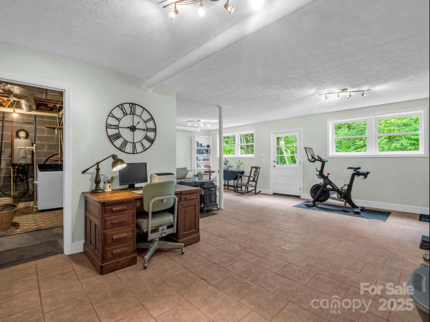 61 Overbrook Drive, Saluda, NC 28773.  MLS# CAR4281023, YatesRealty ID 27373. Basement living space with it's own exterior and also a room for laundry in basement!