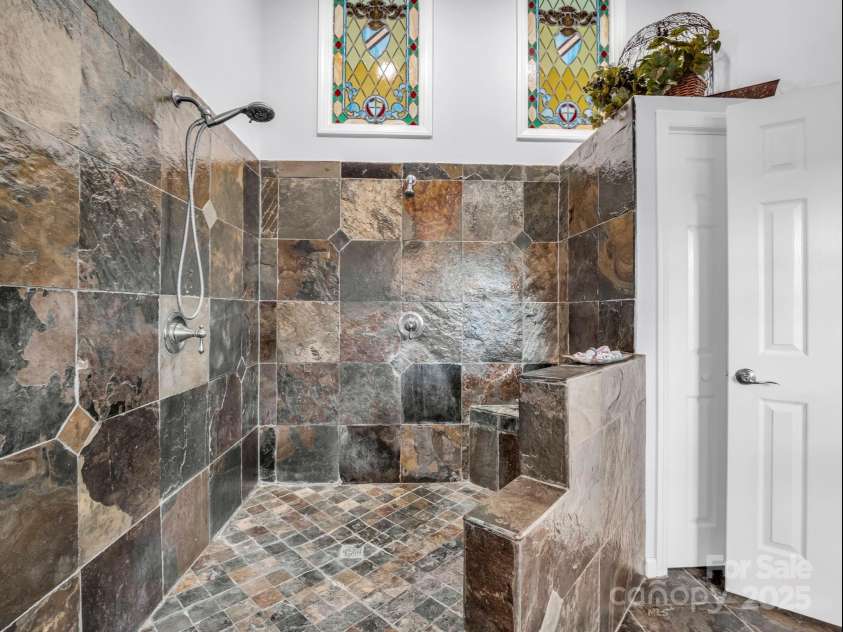 61 Overbrook Drive, Saluda, NC 28773.  MLS# CAR4281023, YatesRealty ID 27373. Wait until you see this walk-in shower in the primary/mud room for the primary suite... come in from the garden take off your clothes and clean up! :) 