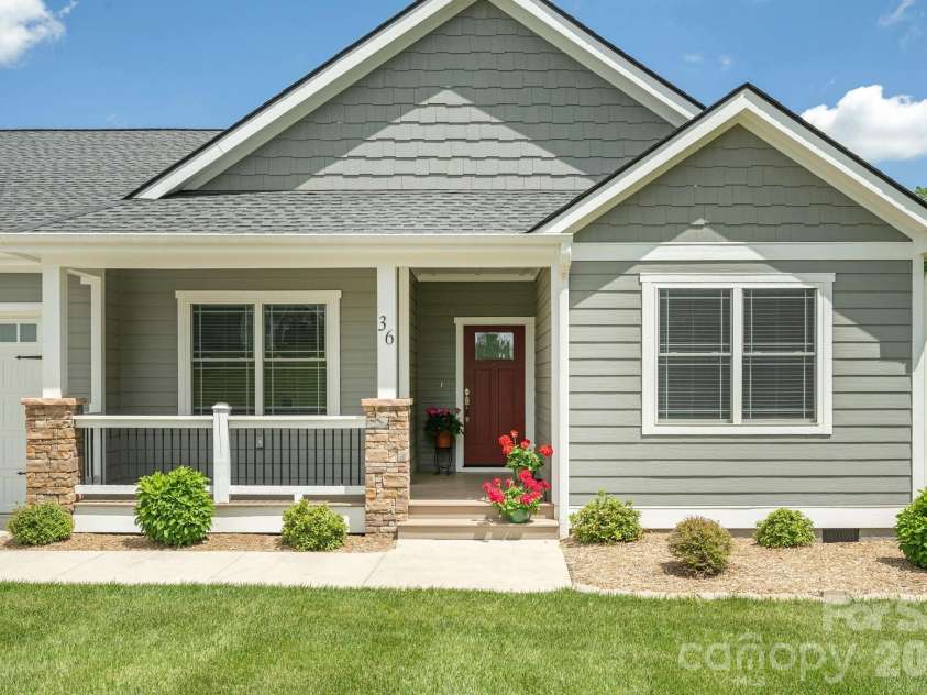 36 Windy Acres Knoll Drive, Hendersonville, NC 28792.  MLS# CAR4377336, YatesRealty ID 27383. Front Entry Detail – Inviting covered front porch with stone columns and charming entry creates a warm first impression for guests.