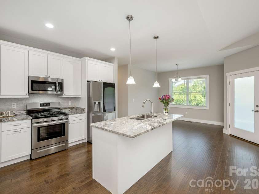 36 Windy Acres Knoll Drive, Hendersonville, NC 28792.  MLS# CAR4377336, YatesRealty ID 27383. Kitchen & Dining Area – Expansive kitchen with oversized island overlooks the dining area and great room, maximizing the home's open and functional floor plan.