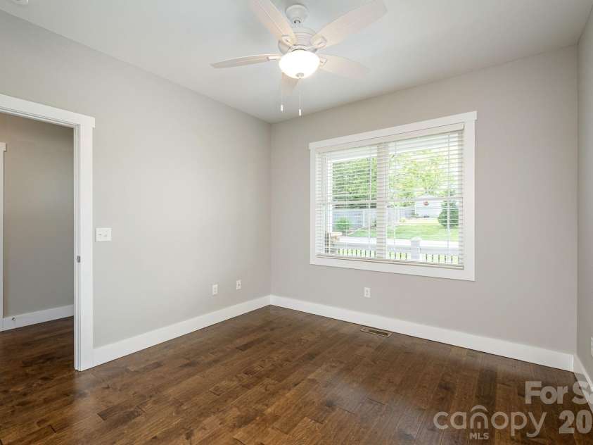 36 Windy Acres Knoll Drive, Hendersonville, NC 28792.  MLS# CAR4377336, YatesRealty ID 27383. Secondary Bedroom – Versatile bedroom with generous natural light and ample space for family, guests, or a home office.