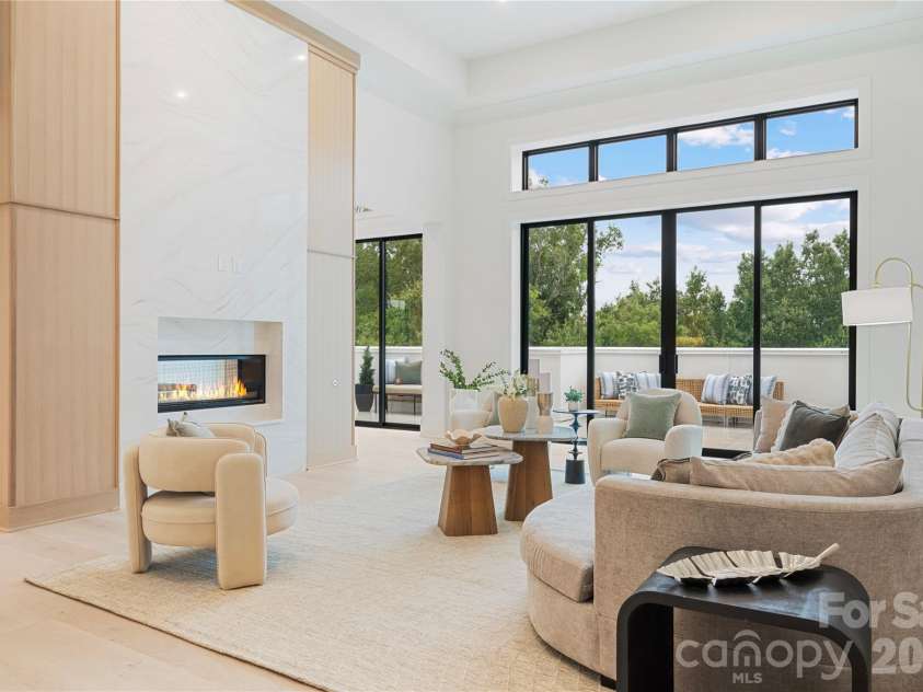 409 Queens Road, Charlotte, NC 28207.  MLS# CAR4425871, YatesRealty ID 274. When entering #503, you step into a light-filled living space with exceptionally tall ceilings, oversized glass doors, treetop views and seamless access to the outdoor private terrace.