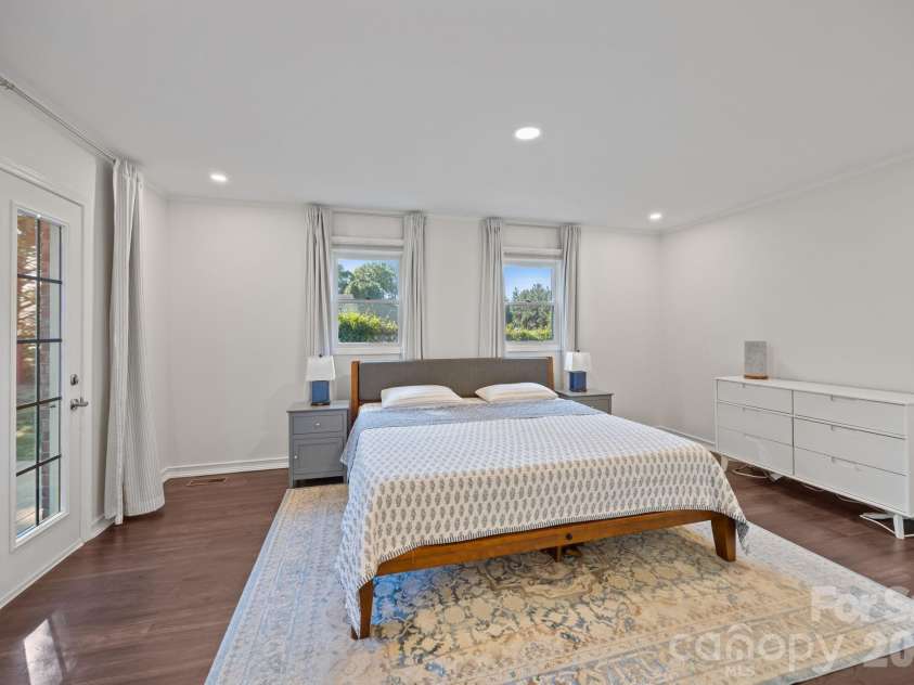 3030 Lydia Lane, Newton, NC 28658.  MLS# CAR4373237, YatesRealty ID 27409. Light-filled primary bedroom with access to rear deck.