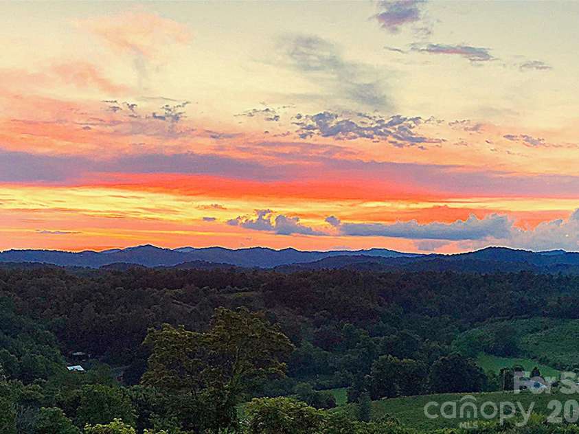1387 Woods Ammons Road, Mars Hill, NC 28754.  MLS# CAR4303363, YatesRealty ID 2741. Back Primary BR Terrace at Sunset - Seller Provided