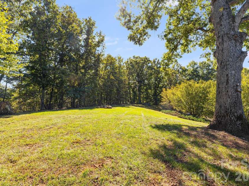 1387 Woods Ammons Road, Mars Hill, NC 28754.  MLS# CAR4303363, YatesRealty ID 2741. Rear yard off of the primary deck - Great croquet field for family games