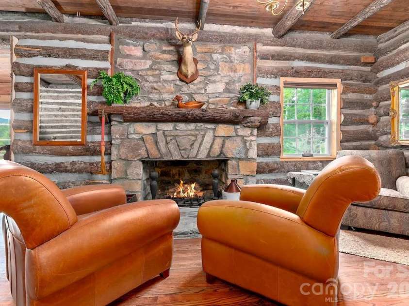 72 Chestnut Hill Road, Gerton, NC 28735.  MLS# CAR4375202, YatesRealty ID 27416. Main Cabin - stone fireplace