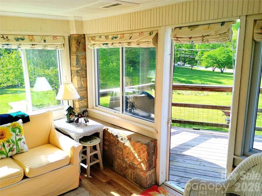 72 Chestnut Hill Road, Gerton, NC 28735.  MLS# CAR4375202, YatesRealty ID 27416. Sunflower Cottage - sunroom with walkout deck