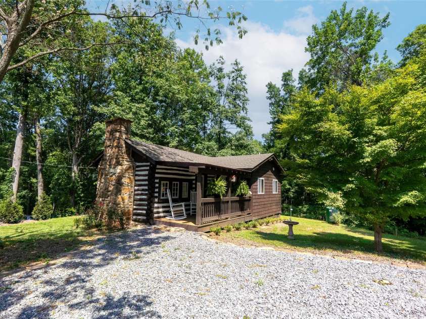 225 Wilderness Road, Tryon, NC 28782.  MLS# CAR4272632, YatesRealty ID 27434. Approach to cabin. Amply parking.