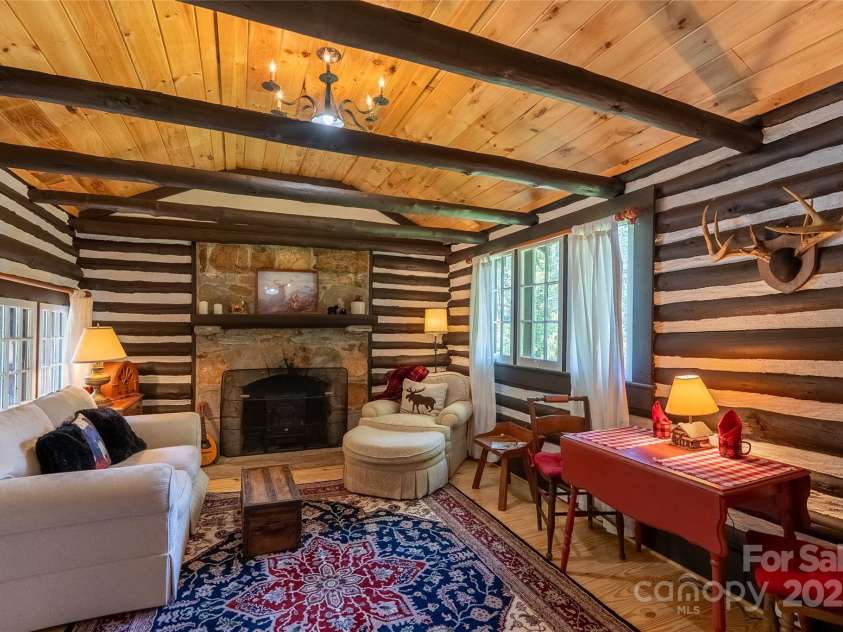 225 Wilderness Road, Tryon, NC 28782.  MLS# CAR4272632, YatesRealty ID 27434. Cozy fireplace & dining for two!