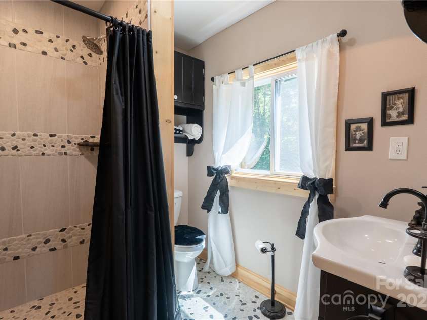 225 Wilderness Road, Tryon, NC 28782.  MLS# CAR4272632, YatesRealty ID 27434. Custom tile shower!