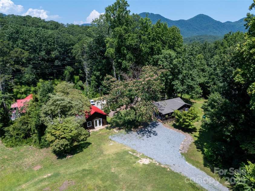 225 Wilderness Road, Tryon, NC 28782.  MLS# CAR4272632, YatesRealty ID 27434. Drone overhead view gives idea of winter views potential