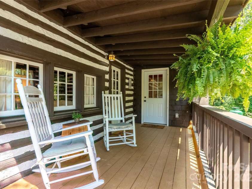 225 Wilderness Road, Tryon, NC 28782.  MLS# CAR4272632, YatesRealty ID 27434. Rocking chair front porch!