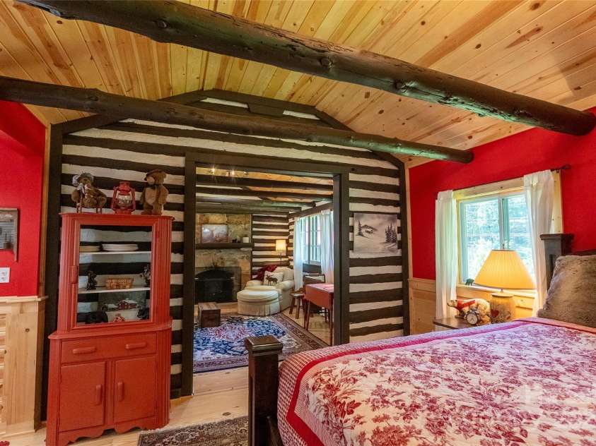 225 Wilderness Road, Tryon, NC 28782.  MLS# CAR4272632, YatesRealty ID 27434. View from Bedroom to Living Room.