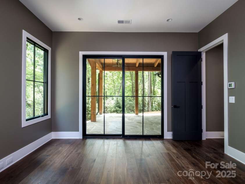 115 Rockbrook Overlook, Brevard, NC 28712.  MLS# CAR4281604, YatesRealty ID 27448. Primary suite with covered patio