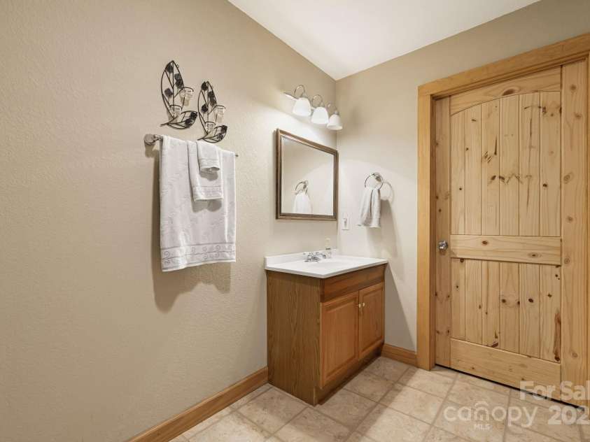 66 Volunteer Drive, Burnsville, NC 28714.  MLS# CAR4278537, YatesRealty ID 27449. Basement Bathroom