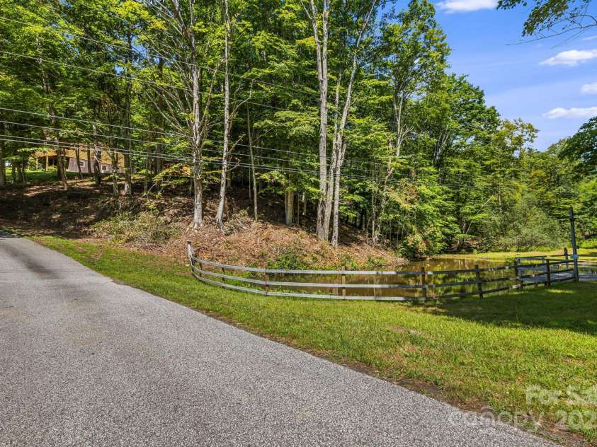 66 Volunteer Drive, Burnsville, NC 28714.  MLS# CAR4278537, YatesRealty ID 27449. Driveway and Pond