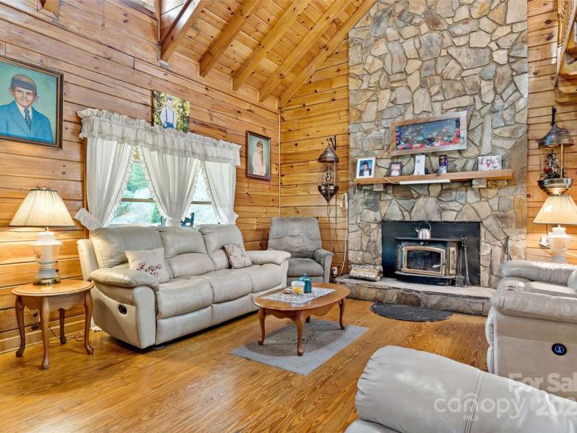 100 Goose Creek Road, Marion, NC 28752.  MLS# CAR4166247, YatesRealty ID 2745. Living room with wood burning fireplace