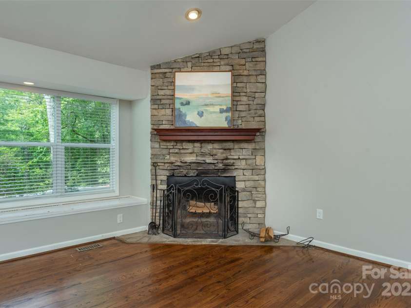 114 Richard Lane, Black Mountain, NC 28711.  MLS# CAR4270307, YatesRealty ID 27456. Beautiful wood-burning fireplace next to the bay window.