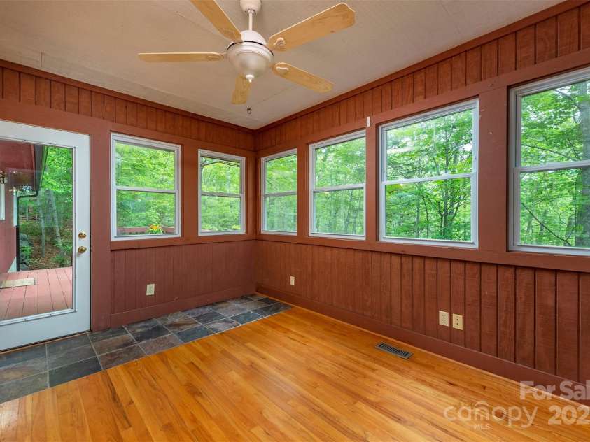 114 Richard Lane, Black Mountain, NC 28711.  MLS# CAR4270307, YatesRealty ID 27456. Sunroom off the primary with access to the deck.