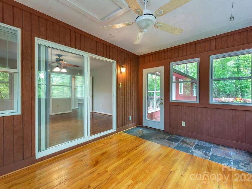 114 Richard Lane, Black Mountain, NC 28711.  MLS# CAR4270307, YatesRealty ID 27456. Sunroom off the primary with access to the deck.