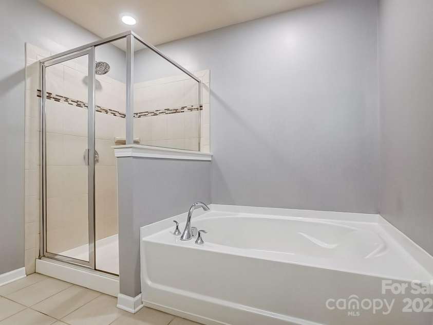 3033 Honeylocust Lane, Fort Mill, SC 29707.  MLS# CAR4214279, YatesRealty ID 2747. Walk-in Shower and Garden Tub