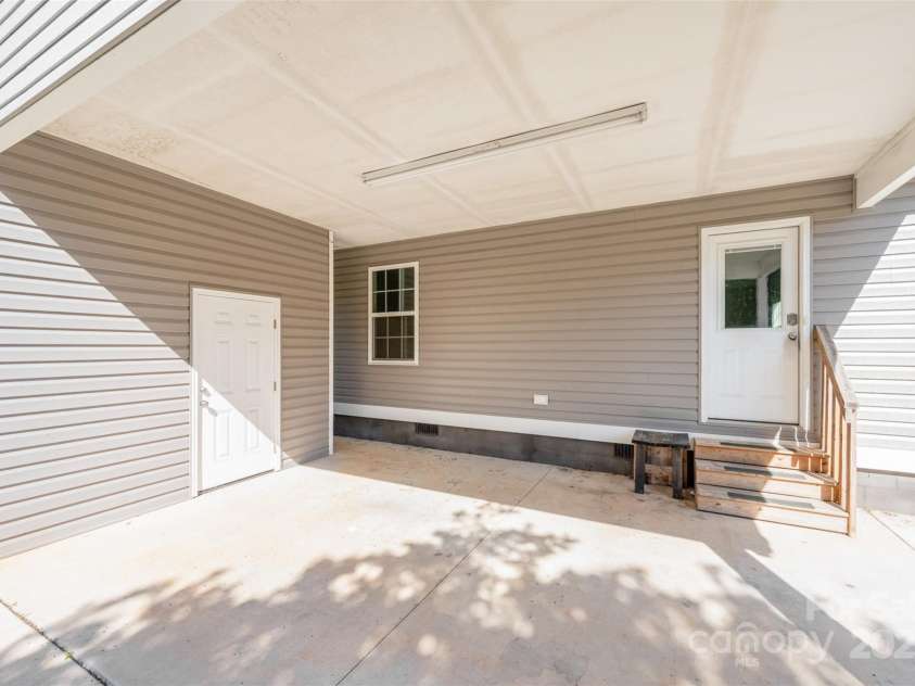 613 Gold Hill Drive, Salisbury, NC 28146.  MLS# CAR4269308, YatesRealty ID 27470. Carport with storage room