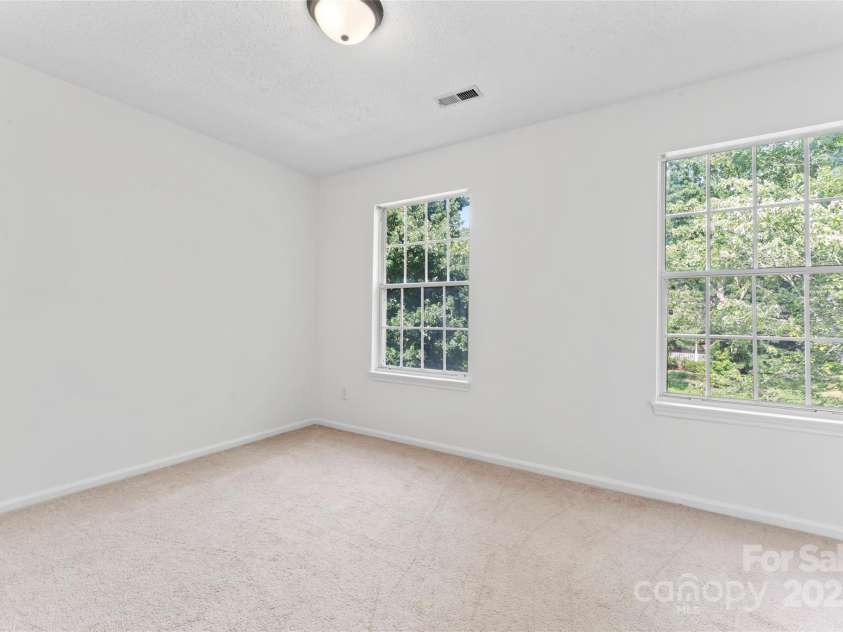 9833 White Cascade Drive, Charlotte, NC 28269.  MLS# CAR4275187, YatesRealty ID 27475. Bedroom #2 with laundry chute in closet