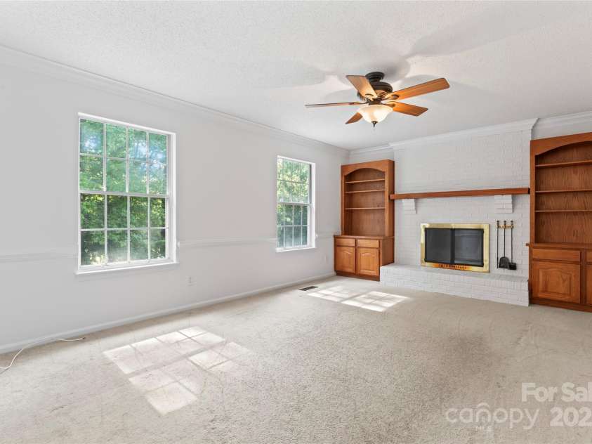 9833 White Cascade Drive, Charlotte, NC 28269.  MLS# CAR4275187, YatesRealty ID 27475. Family room with wood burning fireplace